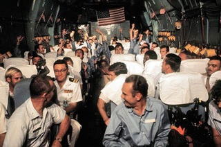 Recently released United States POWs from prison camps in North Vietnamese are flown on board the Hanoi Taxi from Hanoi, North Vietnam to Clark Air Base, Philippines, March 1973.